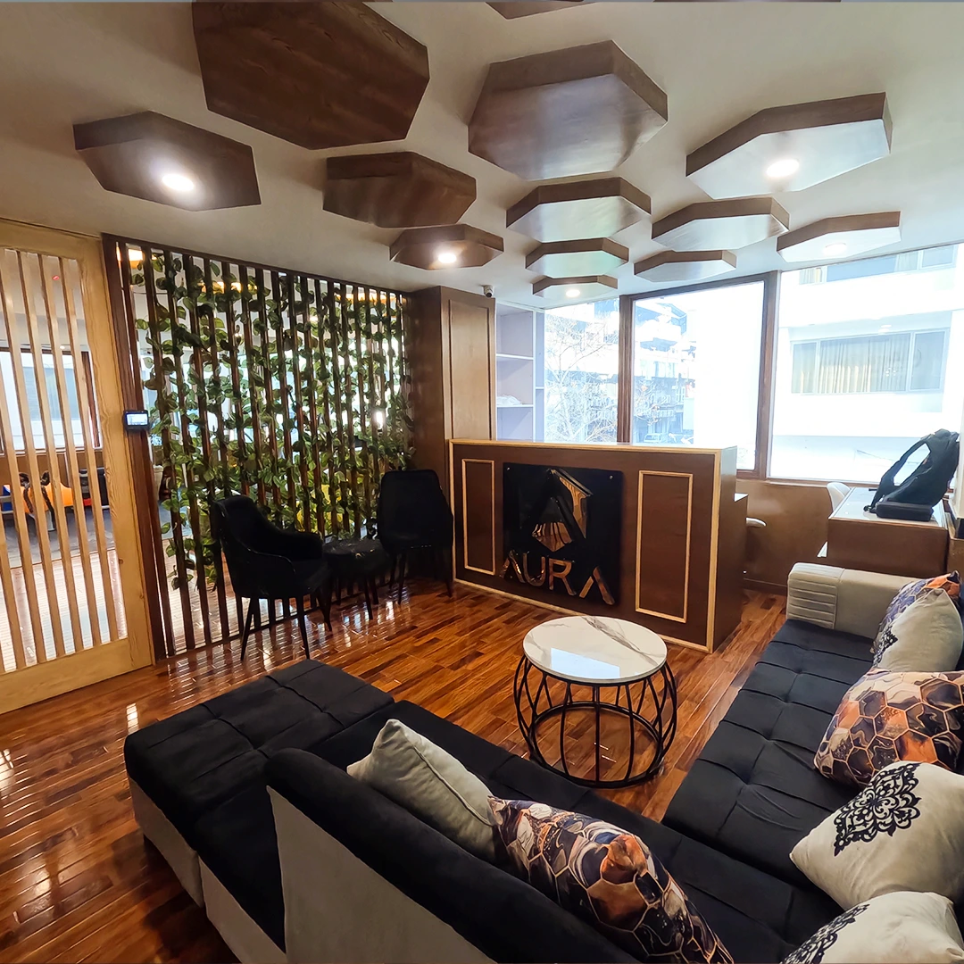 True transformation begins the moment you step into an environment that respects your ambition. At Aura, we have redefined the "gym" as a sanctuary of sophisticated design and peak athletic engineering. Our facility blends the warmth of natural wood finishes with the sharp precision of state-of-the-art equipment. Every element—from the custom hexagonal ceiling architecture to the biophilic green-wall dividers—is curated to transition the mind from the chaos of daily life into a state of deep, athletic focus